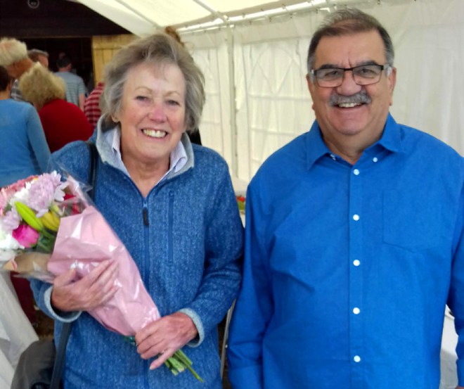A symphony in blue. The show judge with well-earned bouquet flanked by dapper plot-holder