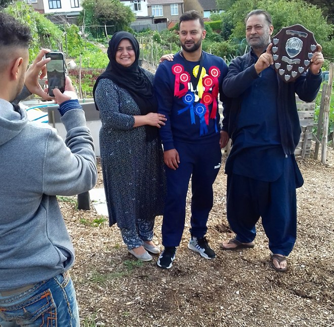 The winner of the Joe Moriarty memorial shield for Plot Holder of the Year flanked by proud parents.