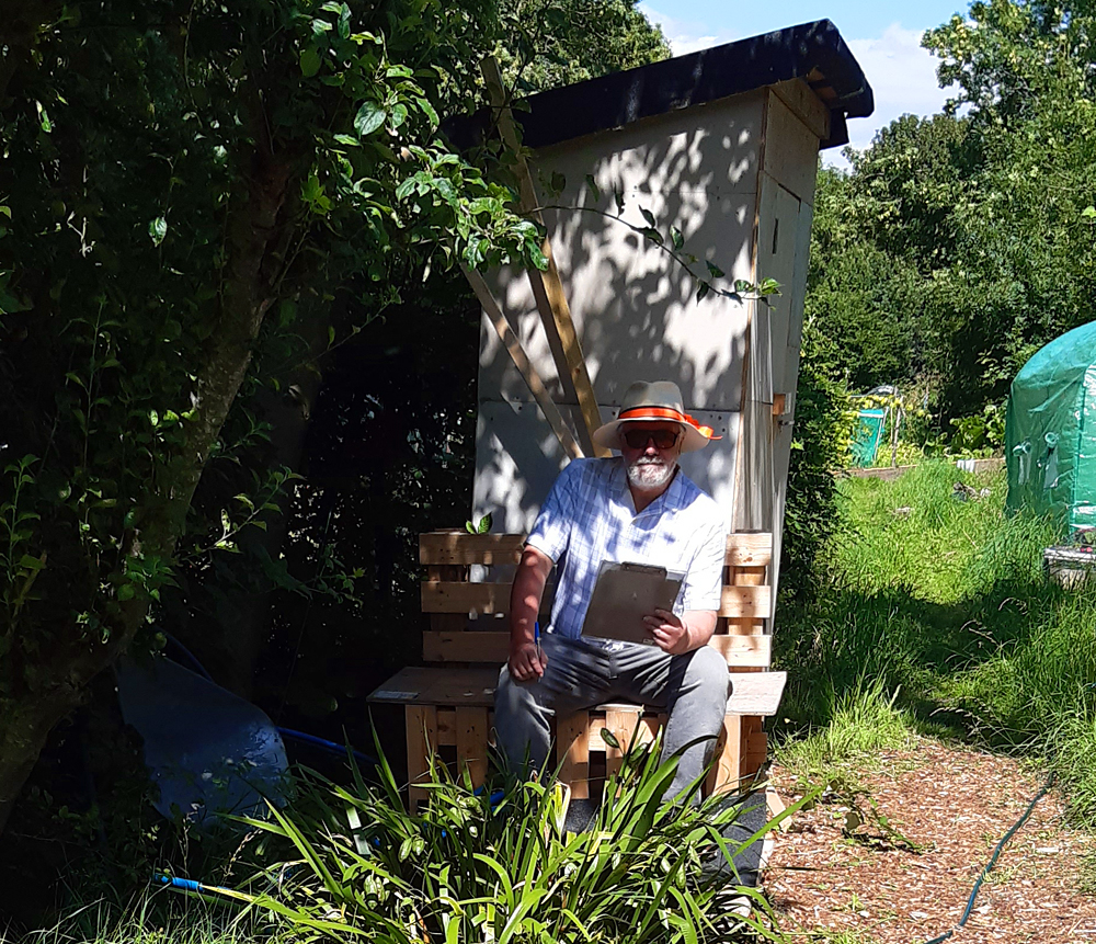 peter sitting on bench made with pallets 2023