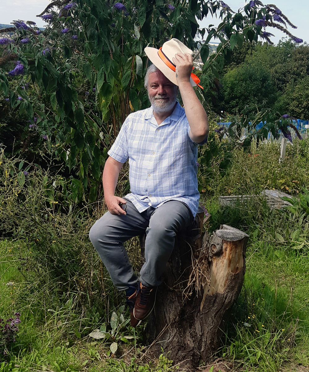 Peter our Plot Holder of The Year judge for 2023 perching on a natural 'bar stool'.